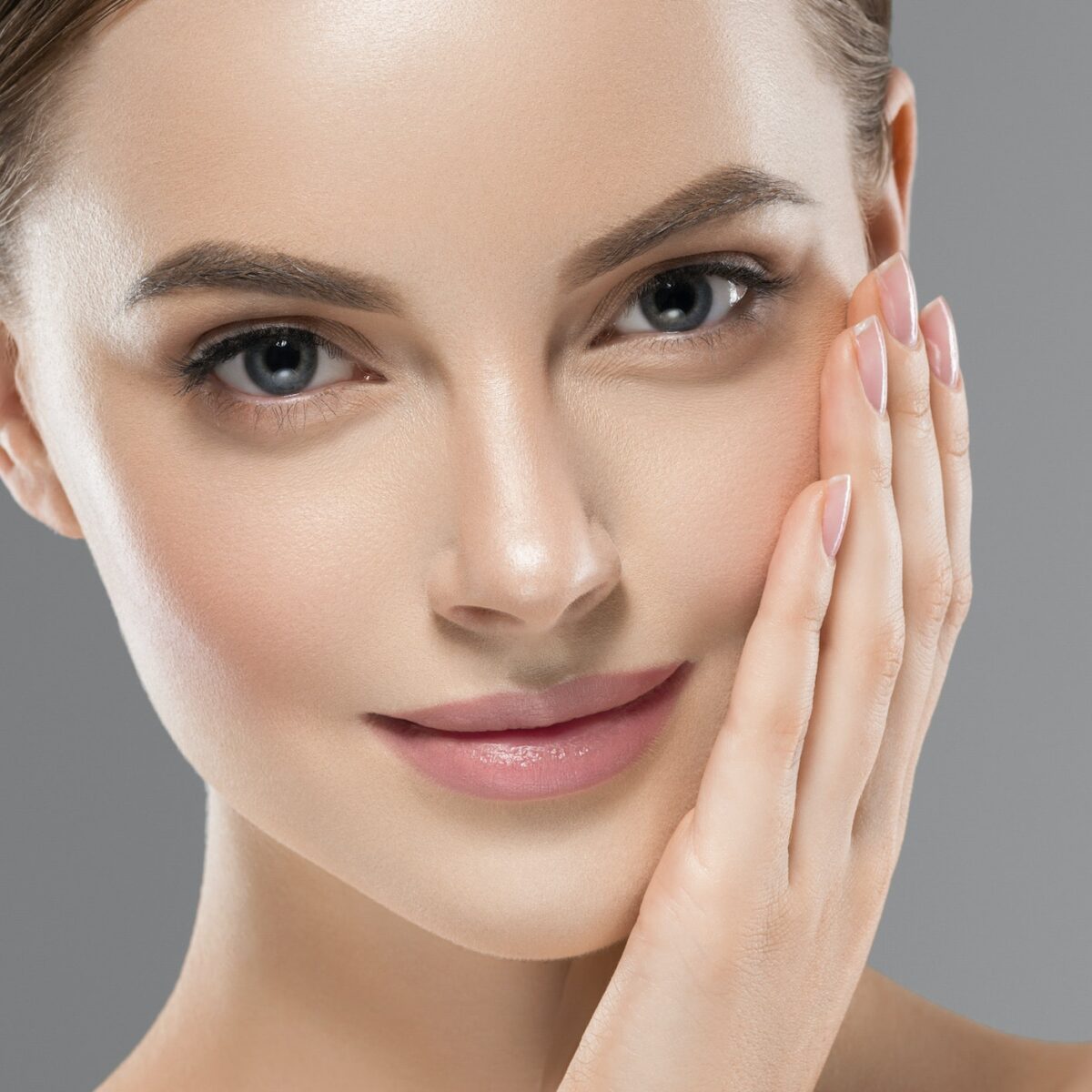 Beautiful face woman healthy skin gray background