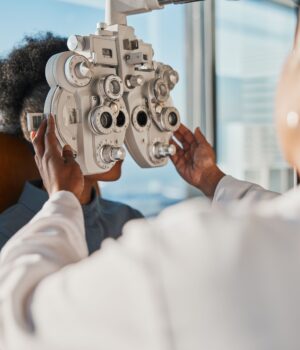Optometry, healthcare and optometrist doing a eye test for a patient for vision or eyecare in a cli